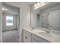 Bright bathroom featuring a double vanity with white countertops and a large mirror at 261 Mayflower Dr., Calabash, NC 28467