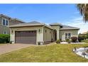 Attractive single-story home with a brown two-car garage and well-designed landscaping in front yard at 274 Avenue Of The Palms, Myrtle Beach, SC 29579