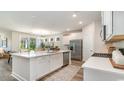 Open kitchen featuring a large center island, stainless steel appliances, and bright white cabinets at 333 Glacier Way, Conway, SC 29526