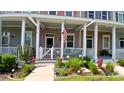 Townhouse with decorative front porch, American flag, and well-maintained landscaping at 3358 Pampas Dr., Myrtle Beach, SC 29577