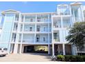 Condo building featuring pastel exterior, stacked balconies and covered parking at 407 24Th Ave. N # 302, North Myrtle Beach, SC 29582