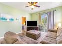 Cozy living room with a view into the bedroom and a sliding door to an outdoor balcony at 488 River Oaks Dr. # 61F, Myrtle Beach, SC 29579