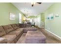 Open-concept living room showcasing the sofa, ottoman, and transition into the kitchen area at 488 River Oaks Dr. # 61F, Myrtle Beach, SC 29579