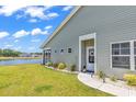 Beautiful home exterior showcasing a serene pond view, well-kept lawn, and tasteful landscaping at 528 Courtridge Loop, Conway, SC 29526
