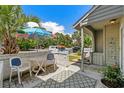 Outdoor patio furnished with a table, chairs, and an umbrella offering a cozy space for relaxation and entertaining at 55 Shadow Moss Pl. # 55, North Myrtle Beach, SC 29582