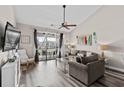 Bright living room showcases vaulted ceilings, ceiling fan, stylish decor and sliding glass doors to the balcony at 5751 Oyster Catcher Dr. # 334, North Myrtle Beach, SC 29582