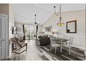 Open-concept living room features vaulted ceilings, modern furnishings, and a sliding door to a private patio at 5751 Oyster Catcher Dr. # 334, North Myrtle Beach, SC 29582