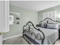 Serene bedroom with a decorative iron bed frame, neutral walls, and shuttered windows for a relaxing retreat at 5905 South Kings Hwy. # 135, Myrtle Beach, SC 29575
