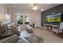 Comfortable living room features hardwood floors, a ceiling fan, and modern wall accents at 6095 Catalina Dr. # 1613, North Myrtle Beach, SC 29582
