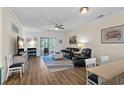 Cozy living room with wood floors, ceiling fan, balcony access, and comfortable seating at 6253 Catalina Dr. # 422, North Myrtle Beach, SC 29582