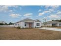 Exterior view of a light gray home with a manicured lawn and blue skies at 627 Culmen Ct., Myrtle Beach, SC 29588