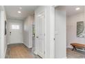 Bright hallway showcasing the front door, neutral walls, and wood-look floors at 627 Culmen Ct., Myrtle Beach, SC 29588