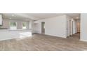 Spacious living space featuring modern wood-look floors and seamless flow to the kitchen at 647 Culmen Ct., Myrtle Beach, SC 29588