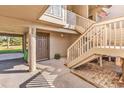Exterior view of entryway featuring covered parking, stairs to the main entrance, and mature trees at 66 Lakeview Circle # 106, Pawleys Island, SC 29585