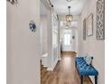 Elegant entryway with a barn door, chandelier lighting, and stylish bench seating near the front door at 684 Wailea Circle, Little River, SC 29566