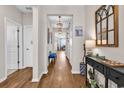 Inviting hallway features stylish decor, elegant lighting, and wood flooring leading to various rooms of the home at 684 Wailea Circle, Little River, SC 29566