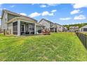 Spacious backyard featuring green grass and a screened porch at 732 Mustang Ranch Dr., Myrtle Beach, SC 29588