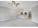Open concept living room featuring plush carpet, ceiling fan, and a pass through to the kitchen at 901 Knoll Shores Ct. # 304, Murrells Inlet, SC 29576