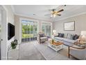 Cozy staged living room with plush seating, TV, area rug and sliding glass doors to an outdoor balcony at 901 Knoll Shores Ct. # 304, Murrells Inlet, SC 29576