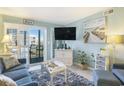 Comfortable living room with access to a balcony and a beach-themed decor at 9581 Shore Dr. # 216, Myrtle Beach, SC 29572