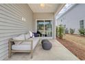 Comfortable back porch with an outdoor couch, decorative pillows, and backyard access at 1013 Hainer Place Dr, Conway, SC 29526