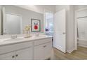 Bright bathroom featuring double vanity, white cabinets, and an attractive mirror at 1013 Hainer Place Dr, Conway, SC 29526