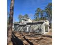 New home features horizontal light beige siding and an attached garage providing modern comfort in a wooded lot at 1028 Colette Ct, Conway, SC 29526