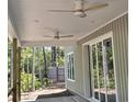 Covered patio with ceiling fans and sliding glass doors offer outdoor living space in a private backyard at 1028 Colette Ct, Conway, SC 29526