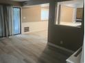 Living room with gray-beige colored walls, hardwood floors, and sliding glass door at 10301 N Kings Hwy. # 22-11, Myrtle Beach, SC 29572