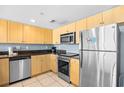 Cozy kitchen features stainless appliances, sleek cabinets and solid surface countertops at 107 S Ocean Blvd. # 1402, Myrtle Beach, SC 29577