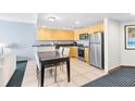 A well-lit kitchen with stainless steel appliances and sleek cabinets adjacent to a dining area at 107 S Ocean Blvd. # 1402, Myrtle Beach, SC 29577