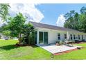 Exterior of the home featuring a Florida room, patio, landscaping, and lawn at 111 Rose Water Loop # 111, Myrtle Beach, SC 29588