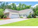 Charming one-story home with an attached garage, well-maintained lawn, and tidy landscaping at 111 Rose Water Loop # 111, Myrtle Beach, SC 29588