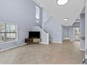Bright, open living space with high ceilings, tile floors, and a staircase at 113A 9Th Ave. S, Surfside Beach, SC 29575
