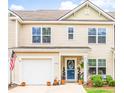 Charming two-story home with a one-car garage, an American flag, and a beautifully decorated entrance at 1147 Fairway Ln. # 1147, Conway, SC 29526