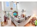 Bright living room with high ceilings, hardwood floors, and a modern ceiling fan for comfortable living at 1147 Fairway Ln. # 1147, Conway, SC 29526