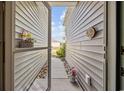 View through an open doorway, showcasing the home's light exterior and landscaped pathway at 125 Mountain Ash Ln., Myrtle Beach, SC 29579