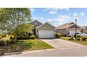 Charming single-story home featuring a well-manicured lawn and an attached two-car garage with a cozy front porch at 125 Mountain Ash Ln., Myrtle Beach, SC 29579