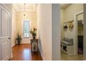 Warm foyer features hardwood floors, tray ceiling, and stylish decor at 1434 Chanson Ct., Little River, SC 29566