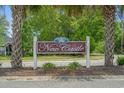 The 'New Castle' neighborhood sign is nestled between two palm trees at 1536 Abberbury Dr., Conway, SC 29527