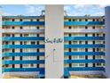 Close exterior image of the building with a decorative sign in the center at 1709 S Ocean Blvd. # 403, North Myrtle Beach, SC 29582