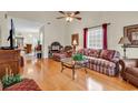 Cozy living room with hardwood floors, ceiling fan, and large windows for natural light at 1729 Longleaf Dr., Myrtle Beach, SC 29575