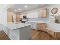 Bright kitchen features custom cabinets, quartz countertops, and hardwood floors at 2180 Waterview Dr. # 1044, North Myrtle Beach, SC 29582