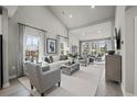 Inviting living room with vaulted ceilings, neutral colors, plush seating, and lots of natural light at 2616 Elowen Ln. # 167B, Longs, SC 29568
