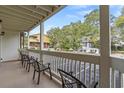 Outdoor balcony featuring seating with a view of parking and neighboring houses at 2805 N Ocean Blvd. # 113, Myrtle Beach, SC 29577