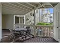 Outdoor patio with seating table perfect for enjoying views of the complex's exterior at 2805 N Ocean Blvd. # 113, Myrtle Beach, SC 29577