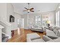 Bright living room with hardwood floors, neutral decor, and plenty of natural light from plantation shutters at 306 River Rock Ln. # 1306, Murrells Inlet, SC 29576