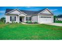 Charming one-story home features a two-car garage, landscaped front yard, and inviting entryway at 3148 Gause Rd., Loris, SC 29569
