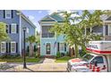 Beautiful two-story house featuring a screened porch, front lawn and mature trees at 3381 Pampas Dr., Myrtle Beach, SC 29577
