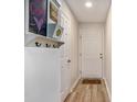 Bright entryway with a coat rack, interior door, and a decorative rug on the wooden floor at 342 Pinehurst Ln. # 12J, Pawleys Island, SC 29585